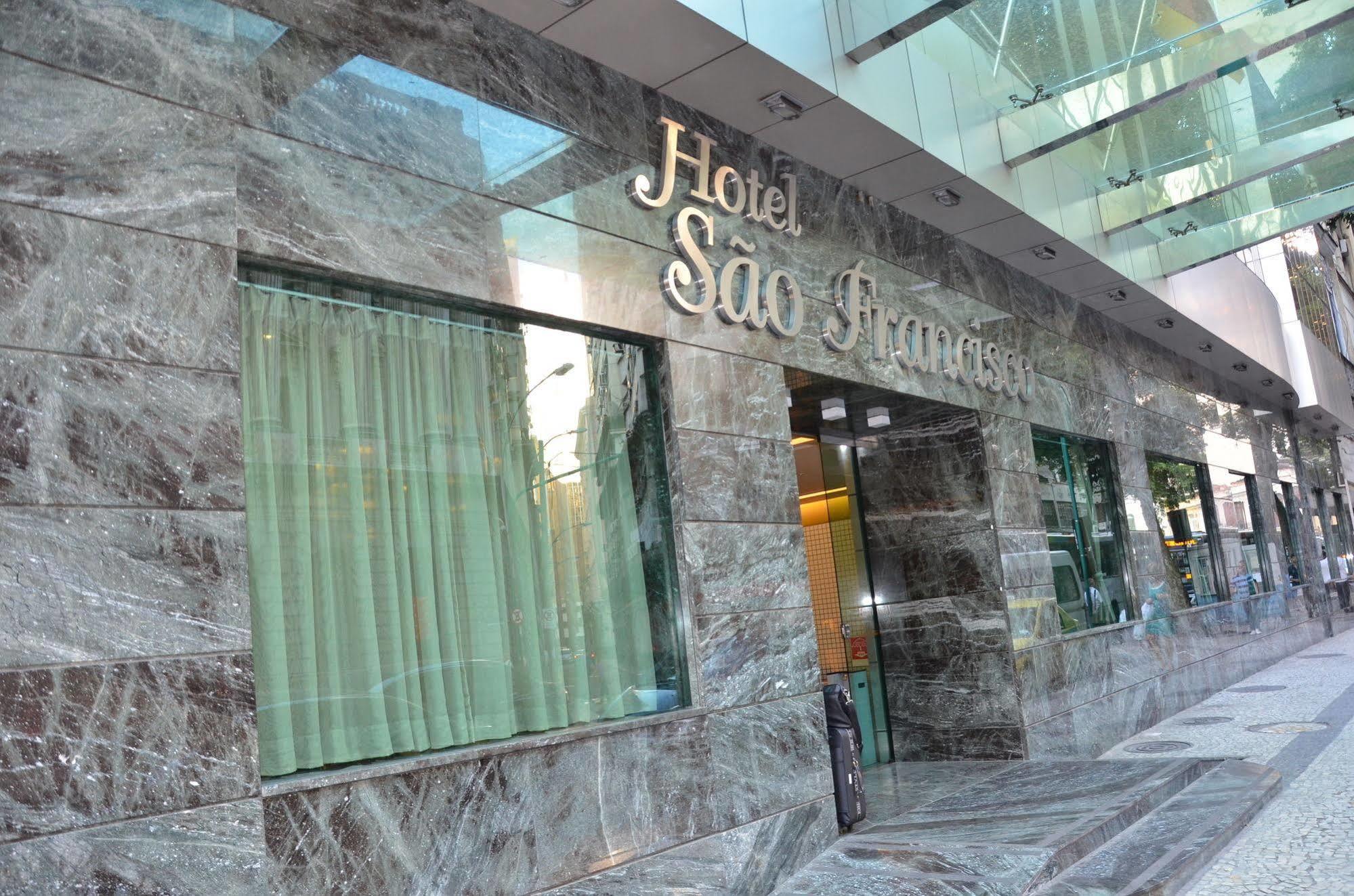 Hotel Atlantico Tower Ρίο ντε Τζανέιρο Εξωτερικό φωτογραφία The photo shows the exterior of a hotel named "Hotel São Francisco." The facade is made of marble, giving it an elegant appearance, and large glass windows are visible, likely allowing natural light to enter the interior. There are light green curtai